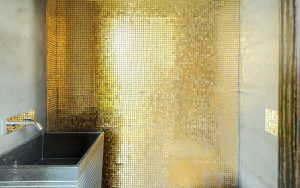 Golden-wall-and-black-bleustone-sink-in-this-contemporary-bathroom-via-Bloggingpet